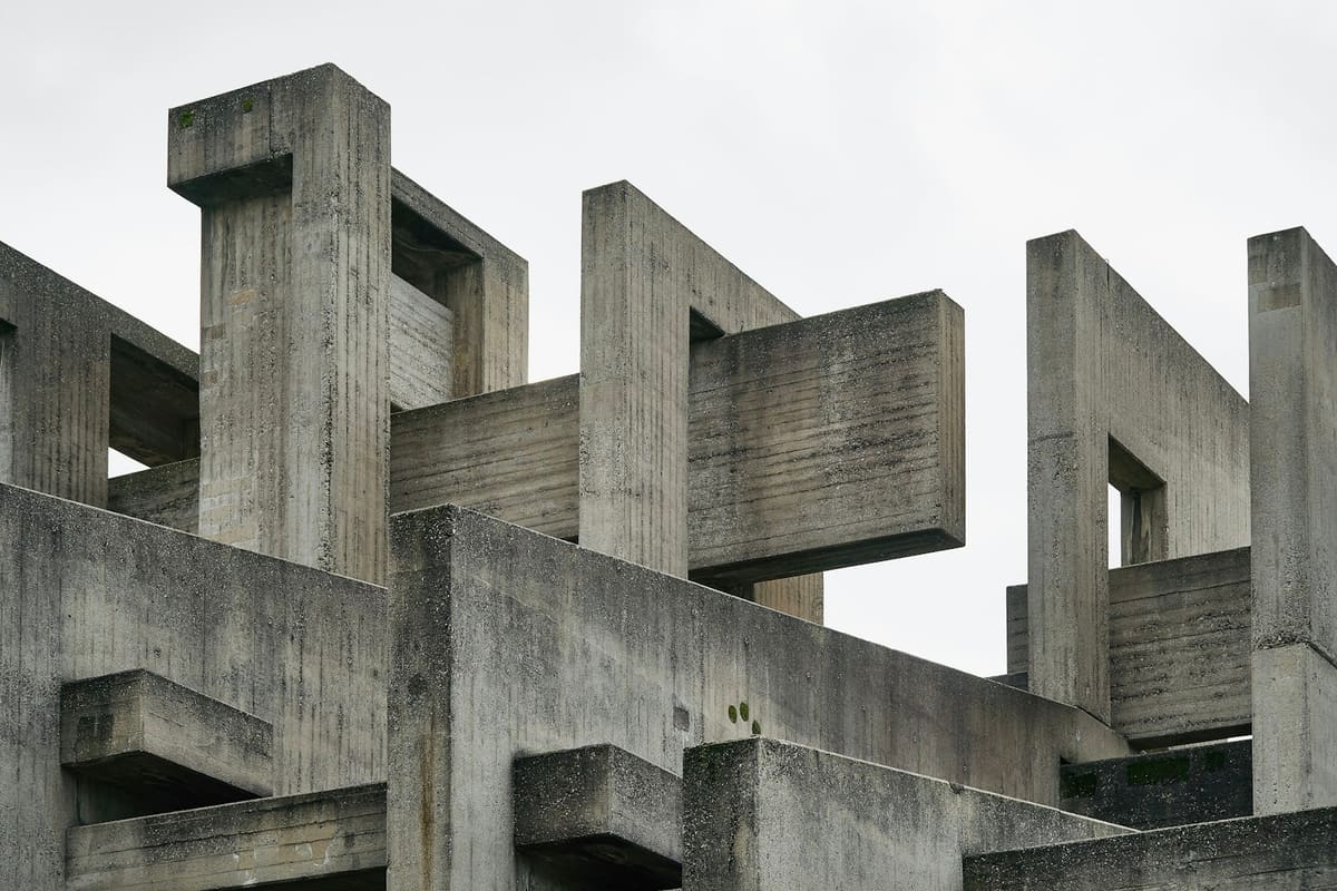Interlocking gray concrete walls against a pale sky